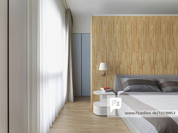 Hartholzboden und -wand in einem modernen Schlafzimmer