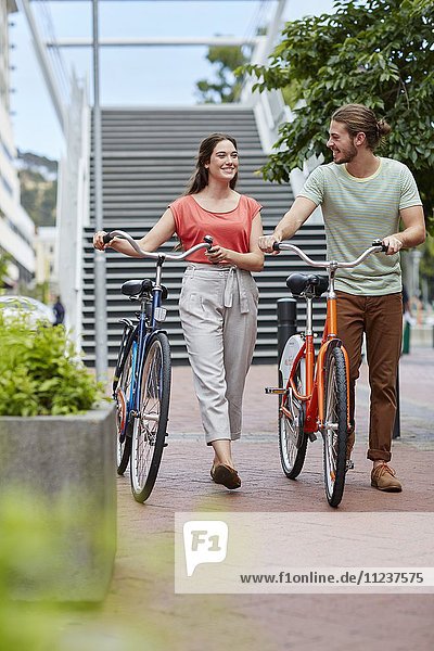 Couple walking with bikes