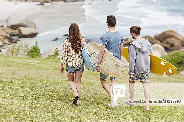 Young people on beach with surfboards