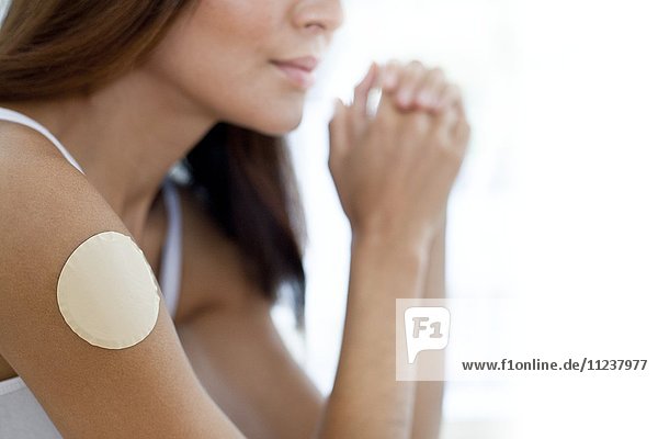 Young woman wearing nicotine patch