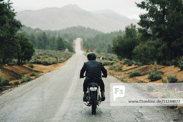 Rückansicht eines Motorradfahrers  der auf offener Straße Motorrad fährt  Kennedy Meadows  Kalifornien  USA
