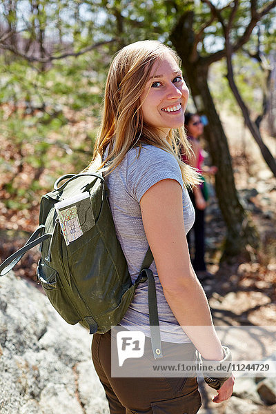 Portrait of woman hiker looking back in forest  Harriman State Park  New York State  USA