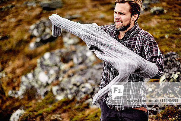 Wanderer zieht Pullover an  Keimiotunturi  Lappland  Finnland