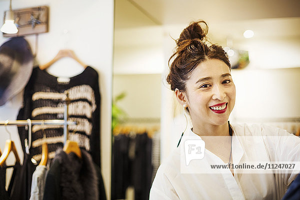 Woman working in a fashion boutique in Tokyo  Japan.