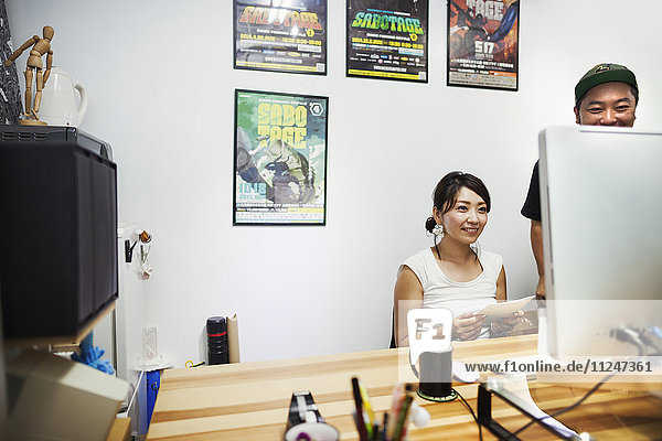 Design Studio. A man and woman looking at a screen.