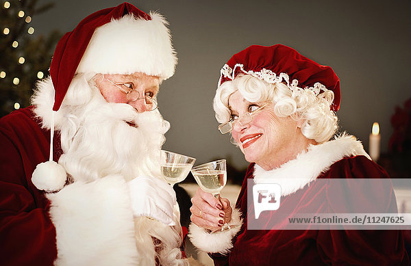 Santa and Mrs. Claus drinking champagne