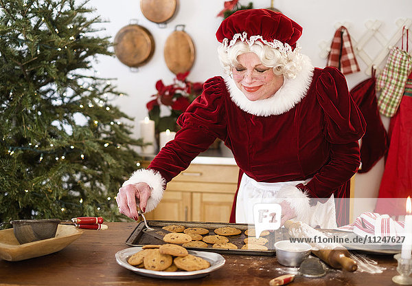 Mrs. Claus making gingerbread cookies