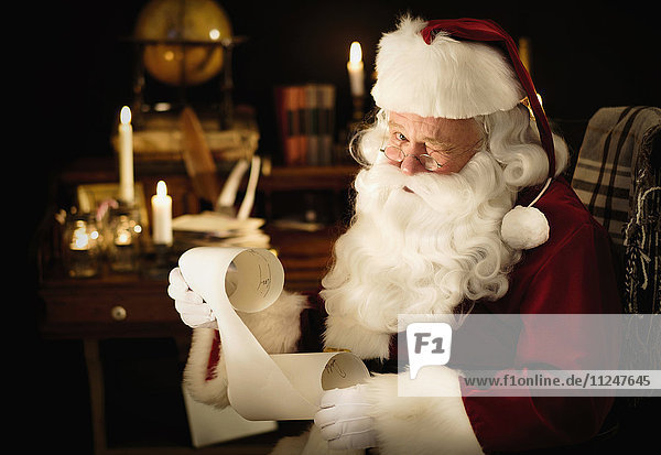 Portrait of Santa Claus reading child's letter and winking