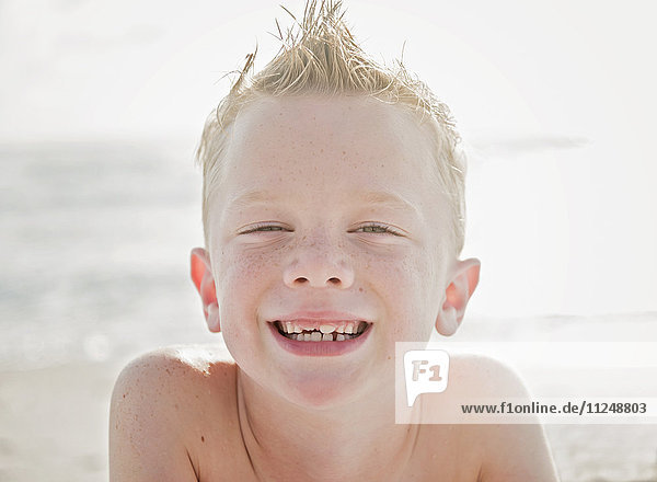 Porträt eines Jungen (6-7) am Strand