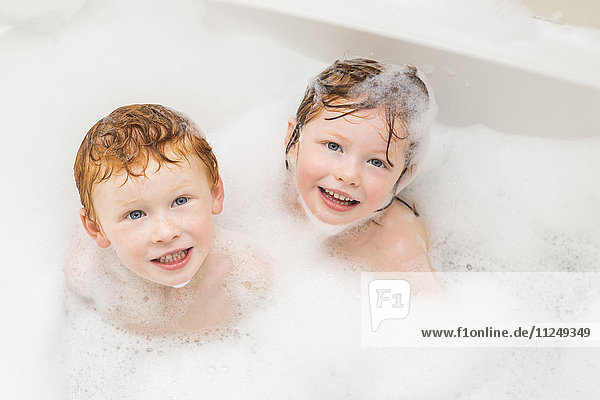 Sister and brother (2-3  4-5) having bubble bath