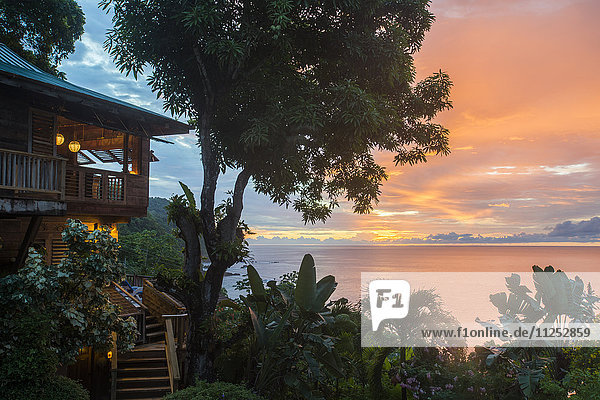 A tree house style apartment in the rainforest faces out to sea at sunset in Castara Bay in Tobago  Trinidad and Tobago  West Indies  Caribbean  Central America