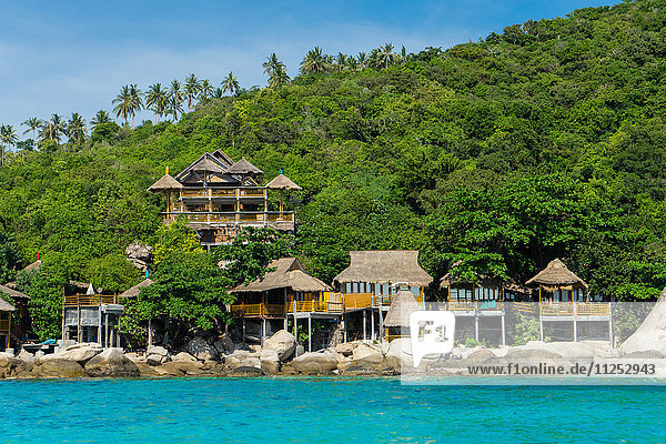 A traditional Thai resort overlooks turquoise water on the tropical island of Koh Tao  Thailand  Southeast Asia  Asia