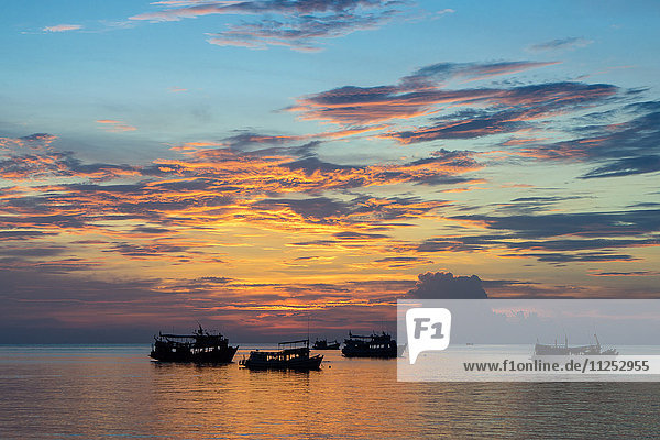 Sun sets over scuba diving boats in Koh Tao  Thailand  Southeast Asia  Asia