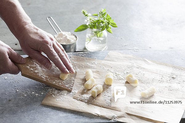 Homemade gnocchi: gnocchi being rolled on a board