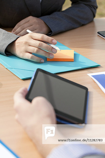 Business people in workshop using digital tablet