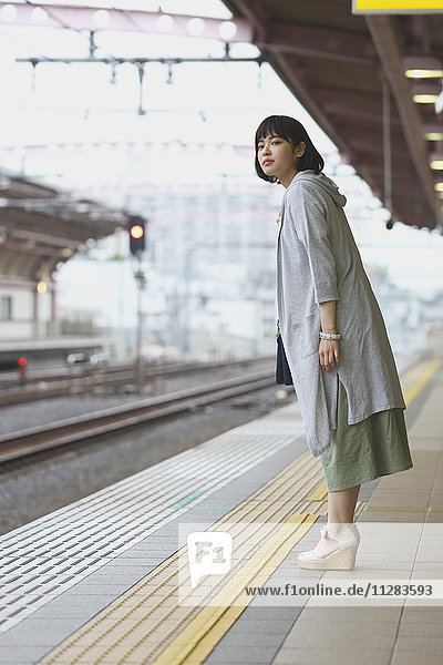 Young Japanese woman at a train station