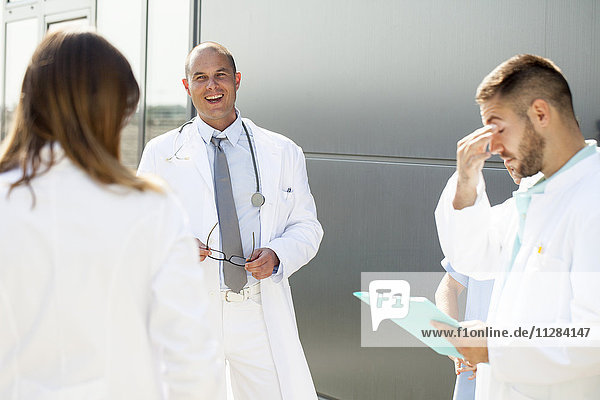 Group of doctors talking outdoors