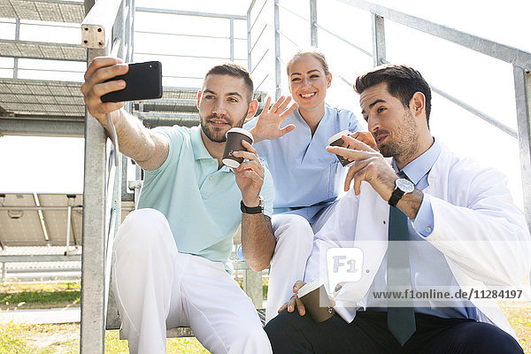 Group of doctors taking a selfie outdoors