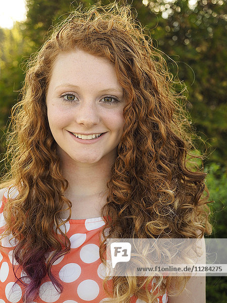 Portrait of smiling Caucasian girl with red hair