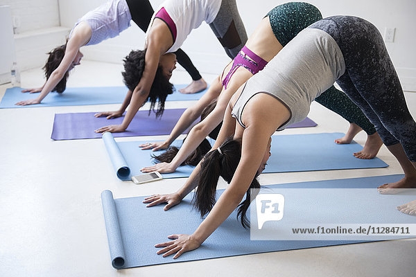 Women bending in yoga class