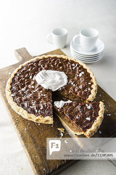 Caramel pecan pie on cutting board