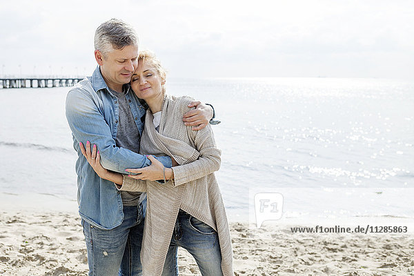 Couple in love embracing on beach