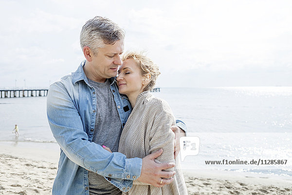 Couple in love standing on beach