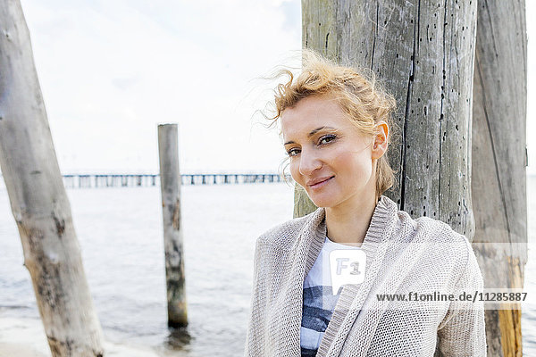 Portrait of woman with blond hair on beach