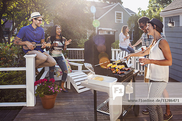 Friends enjoying barbecue on patio