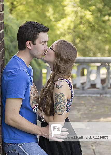 Caucasian couple kissing in park