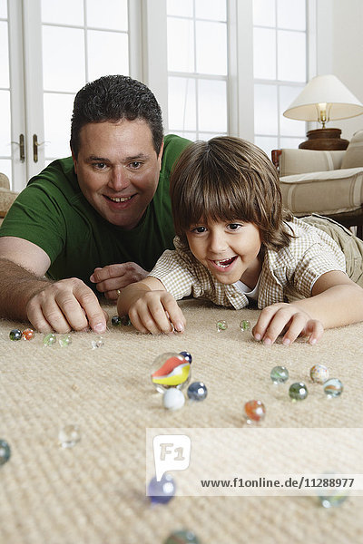 Father and Son Playing With Marbles