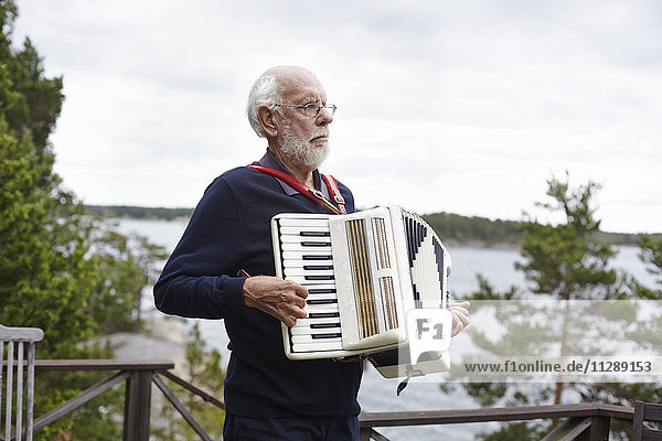 Senior man playing accordion