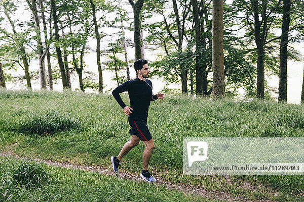 Man running on forest track