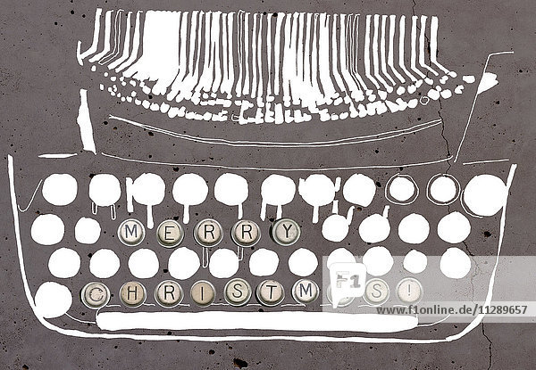 'Merry Christmas' on typewriter key of a stylized typewriter