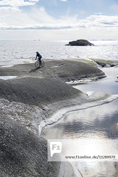 Person cycling at sea