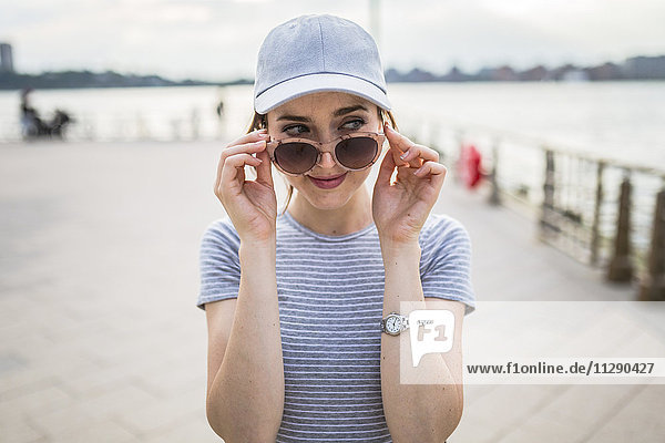 Portrait of woman with sunglasses watching something