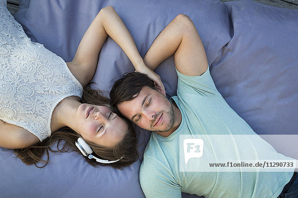 Young couple in love relaxing together on beanbag