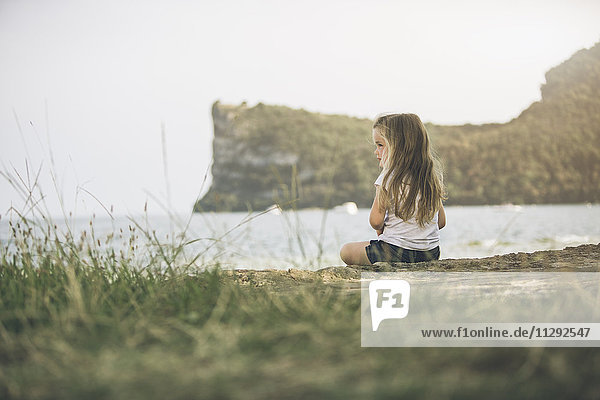 Italy Lake Garda girl sitting at lakeshore