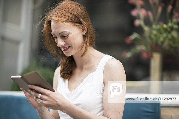 Redheaded woman looking at smartphone