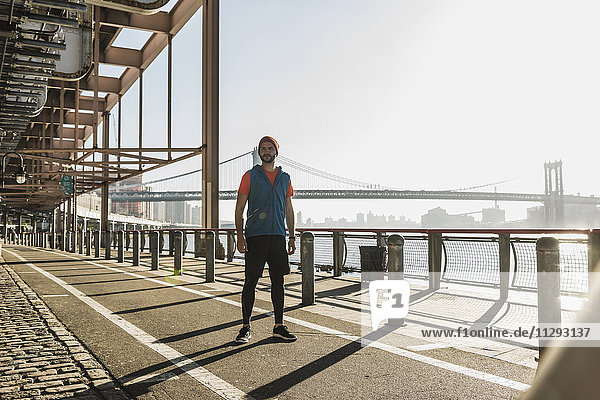 USA  New York City  sportive man standing at East River