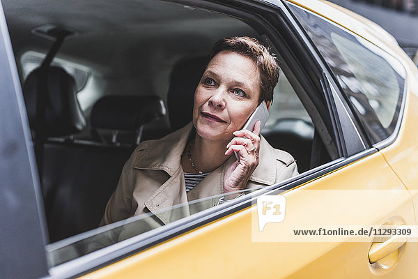 Woman in taxi on cell phone