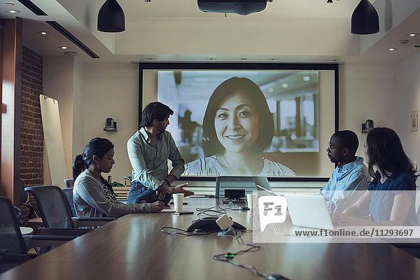 Business people having a video conference in board room