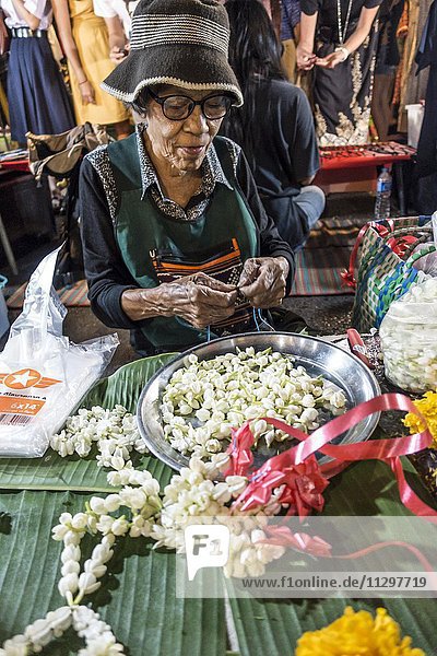 Old Woman Thai Woman Sells Flowers And Flower Chains At The Night Market Krabi Town Krabi Province Thailand Asia