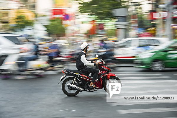 Scooter driver in heavy traffic  motion blur  Ho Chi Minh City  Vietnam  Asia