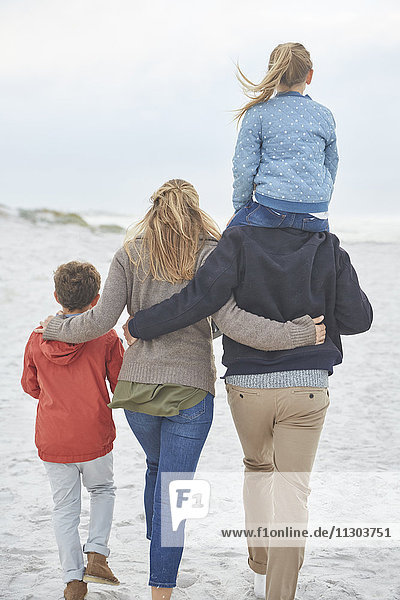 Family walking on winter beach