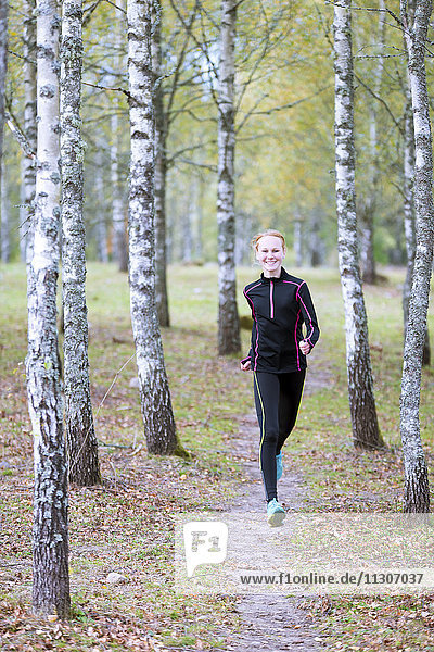 Young woman jogging in forest