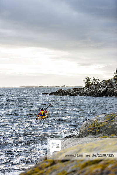 Person kayaking on sea