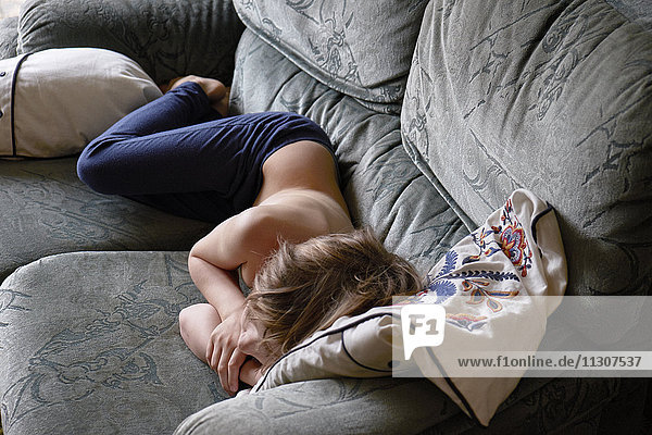 Boy napping on sofa