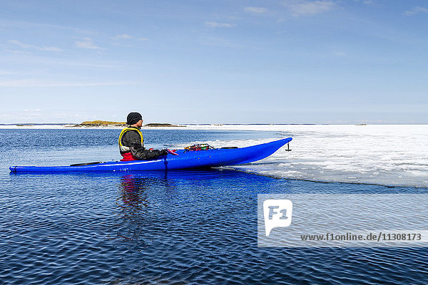 Person kayaking on sea