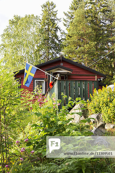 Wooden house with Swedish flag